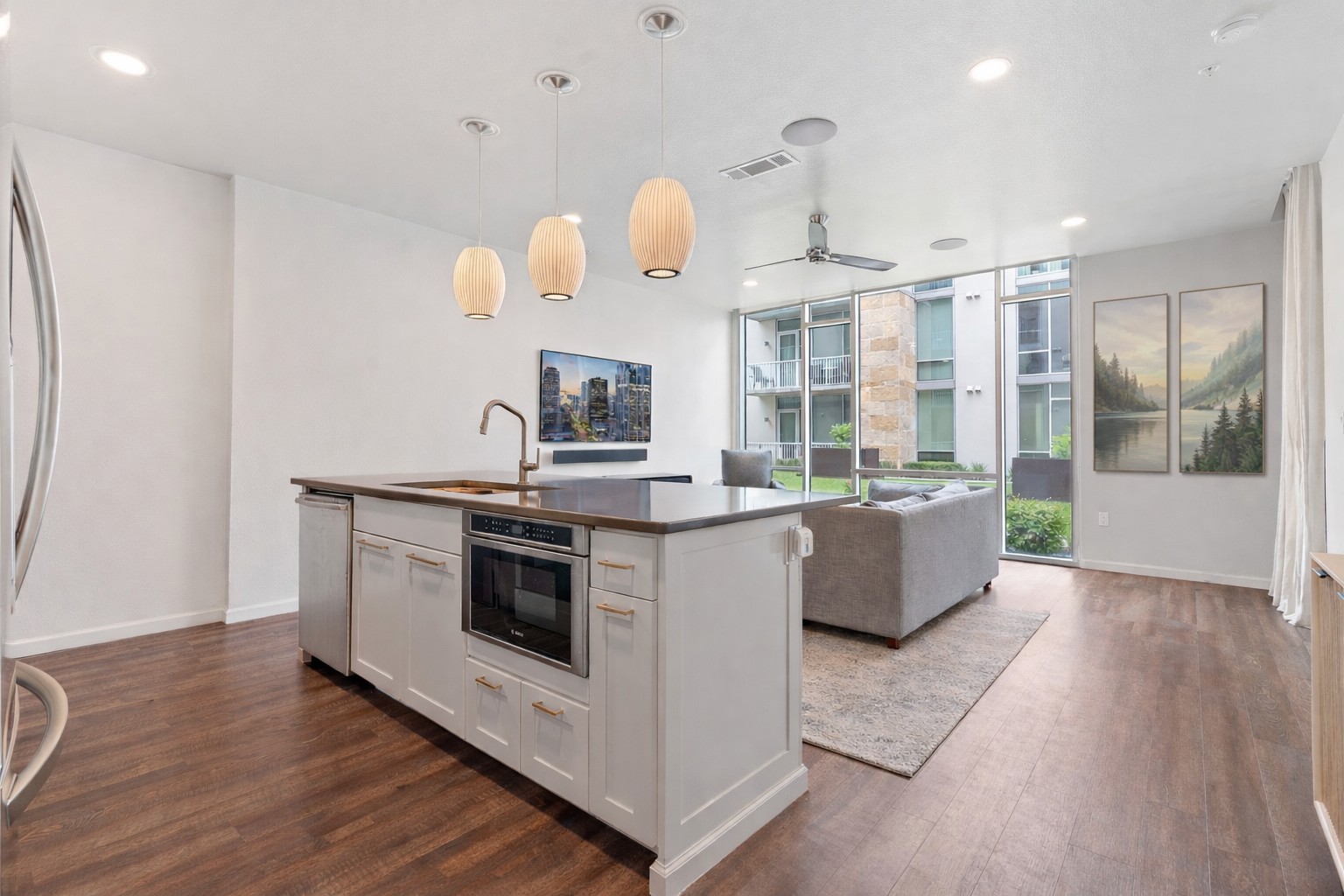 1600 Barton Springs Road, Unit 2102 Austin, TX 78704 - Photo 3 of 37 a large kitchen with kitchen island a large counter top space a sink and stainless steel appliances