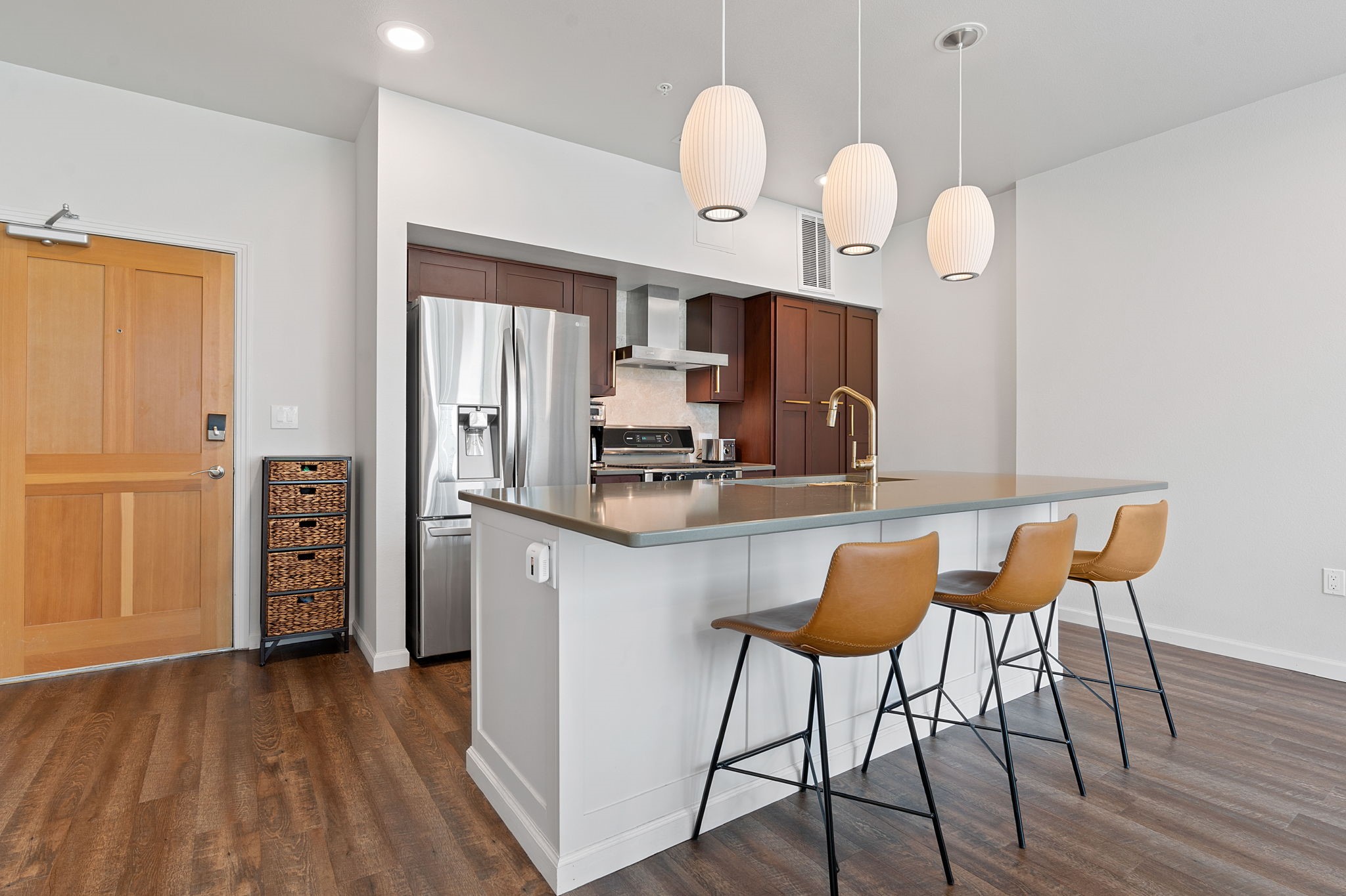 1600 Barton Springs Road, Unit 2102 Austin, TX 78704 - Photo 7 of 37 a kitchen with a table chairs refrigerator and wooden floor
