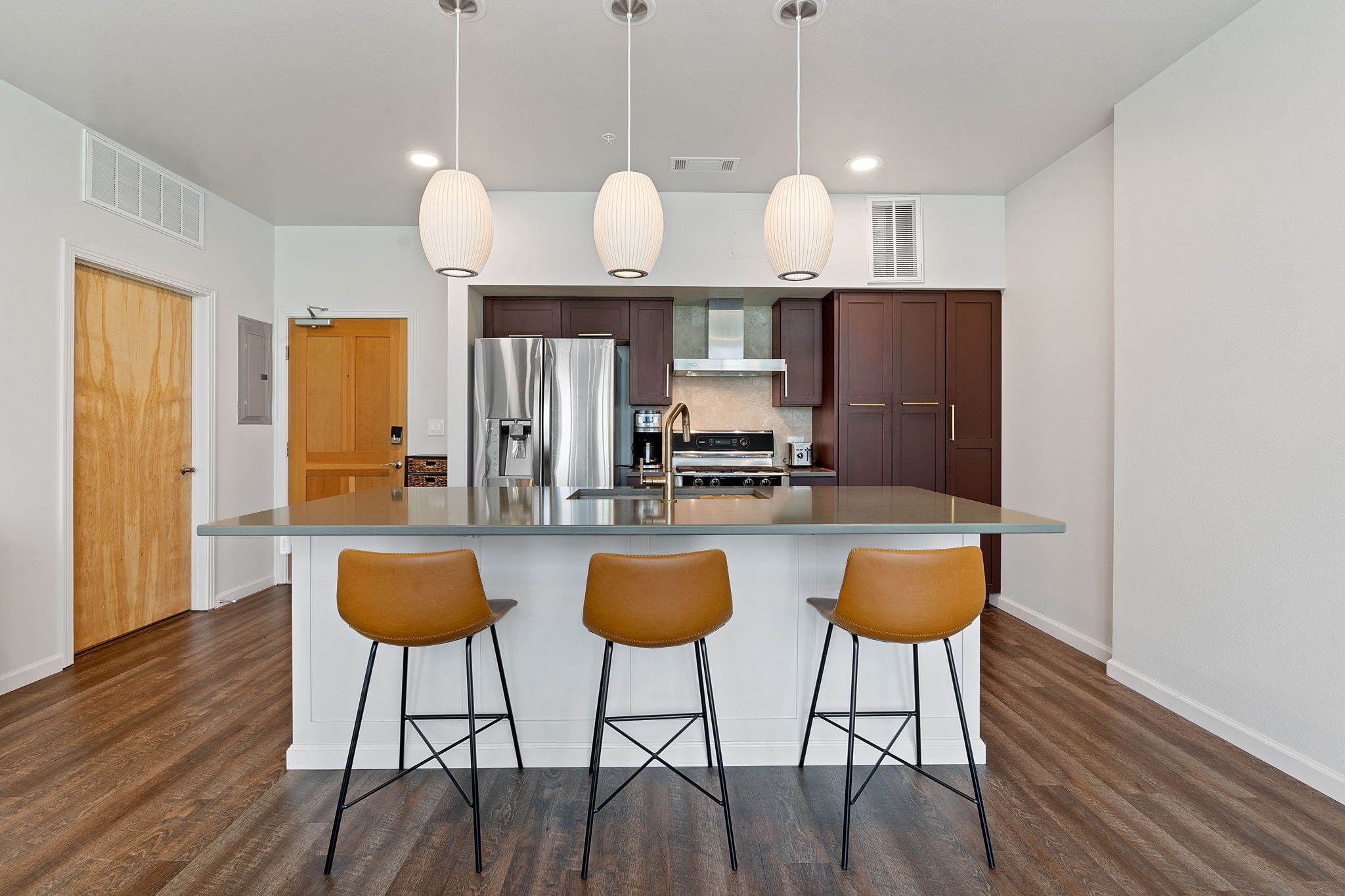 1600 Barton Springs Road, Unit 2102 Austin, TX 78704 - Photo 8 of 37 a kitchen with stainless steel appliances granite countertop a dining table chairs stove and refrigerator