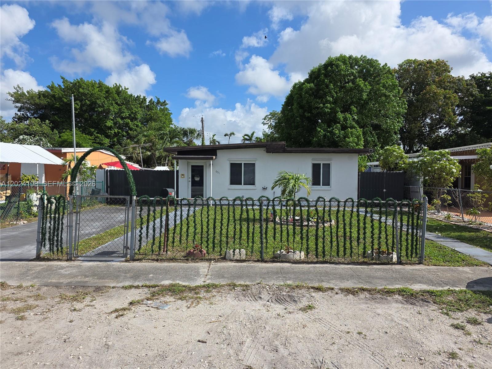 651 East 48th Street Hialeah, FL 33013 - Photo 1 of 52 a front view of a house with a garden and plants
