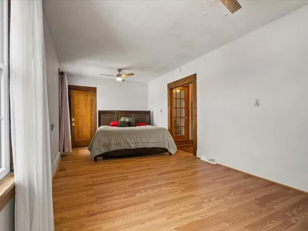 a bedroom with a bed and a dresser