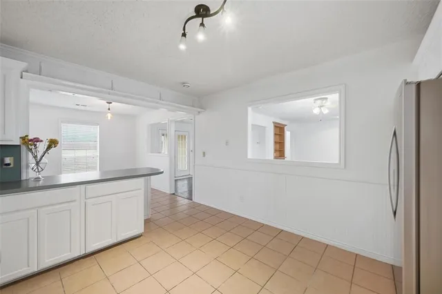 a spacious bathroom with a sink a mirror and a shower
