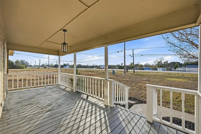 a view of a balcony with wooden floor