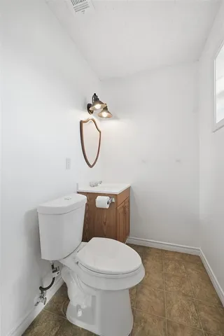 a white toilet sitting next to a shower