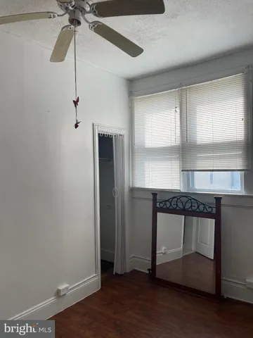 a room with a hardwood and ceiling fan