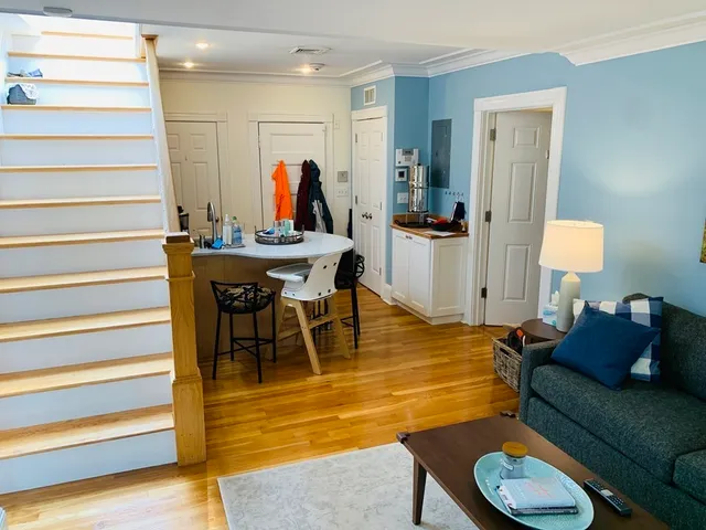 a living room with furniture a rug and a chandelier