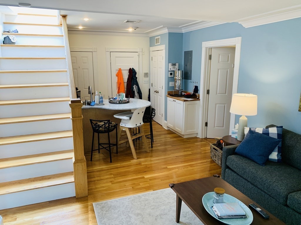 395 Marlborough Street, Unit 8 Boston, MA 02115 - Photo 14 of 19 a living room with furniture a rug and a chandelier