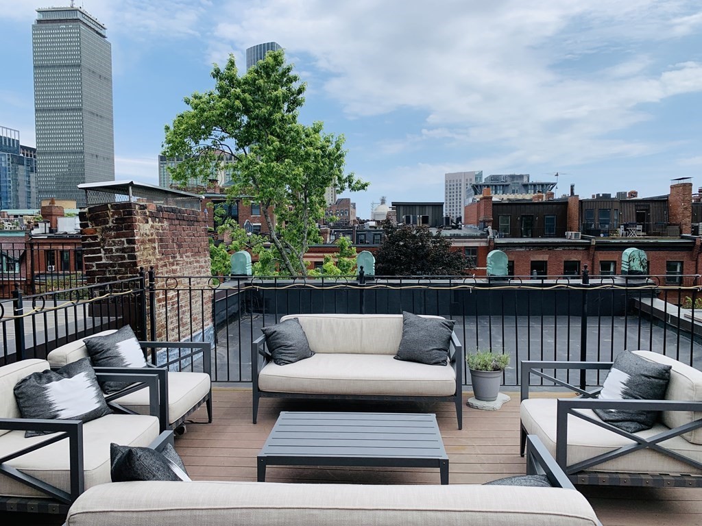 395 Marlborough Street, Unit 8 Boston, MA 02115 - Photo 18 of 19 a view of a terrace with couches and a potted plant on a table