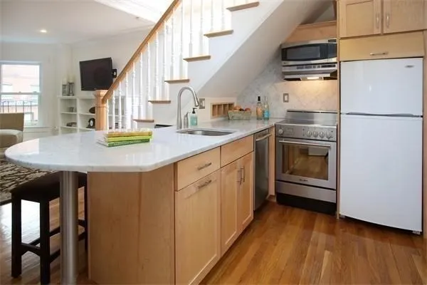 a kitchen with cabinets and stainless steel appliances