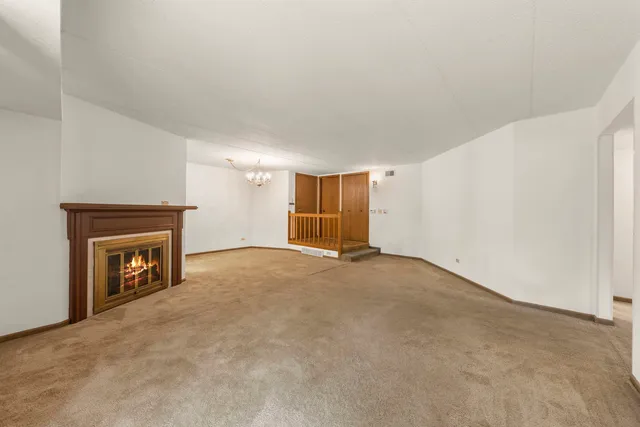 a view of empty room with a fireplace
