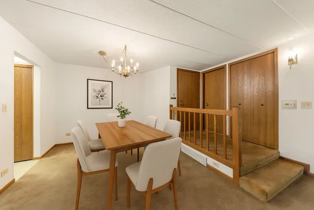 a dining room with furniture and chandelier