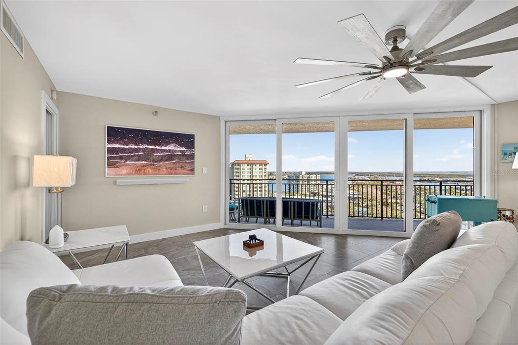 690 Island Way, Unit 1109 Clearwater Beach, FL 33767 - Photo 11 of 37 a living room with furniture ceiling fan and a large window