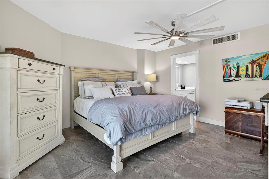 690 Island Way, Unit 1109 Clearwater Beach, FL 33767 - Photo 16 of 37 a bedroom with a large bed and a chandelier