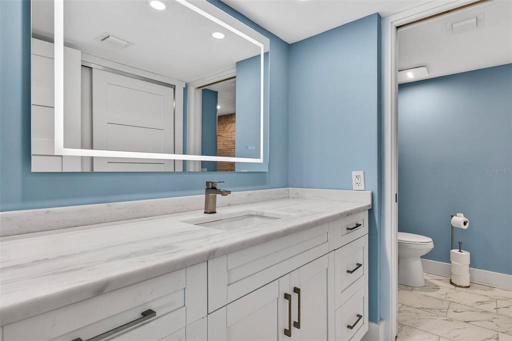 690 Island Way, Unit 1109 Clearwater Beach, FL 33767 - Photo 18 of 37 a bathroom with a sink and a mirror