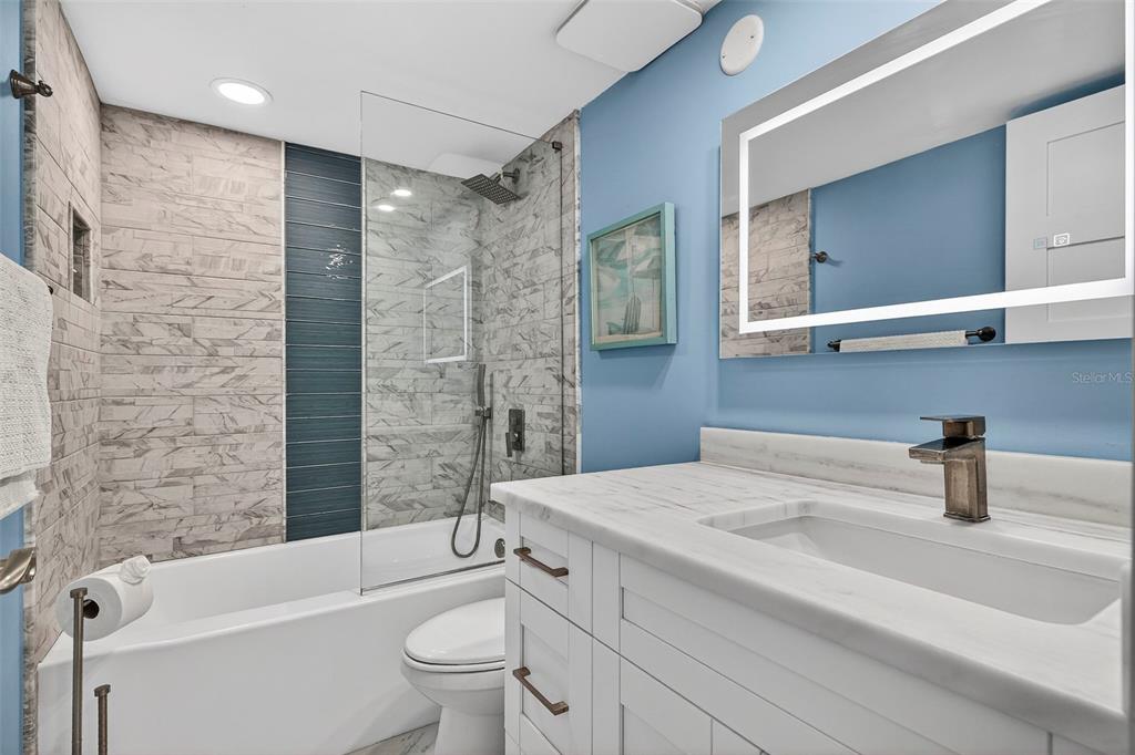 690 Island Way, Unit 1109 Clearwater Beach, FL 33767 - Photo 22 of 37 a bathroom with a sink a toilet and shower