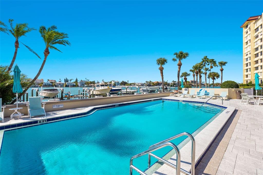 690 Island Way, Unit 1109 Clearwater Beach, FL 33767 - Photo 35 of 37 a view of a swimming pool with a table and chairs