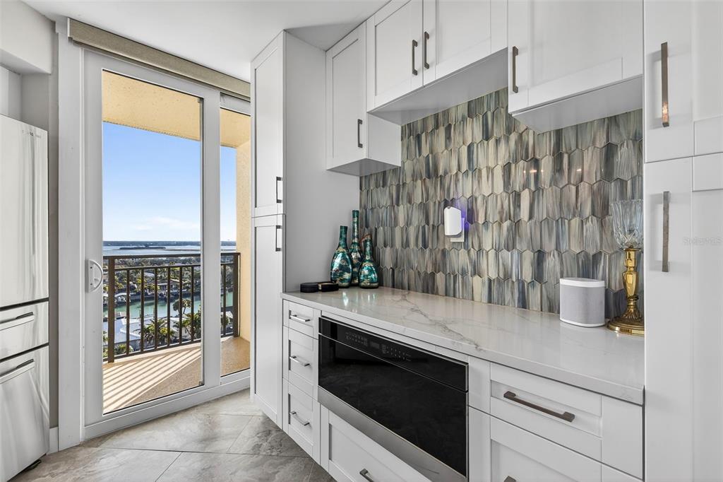 690 Island Way, Unit 1109 Clearwater Beach, FL 33767 - Photo 7 of 37 a kitchen with a refrigerator and a sink