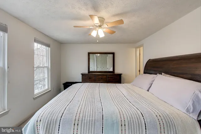 a bedroom with a large bed and a window