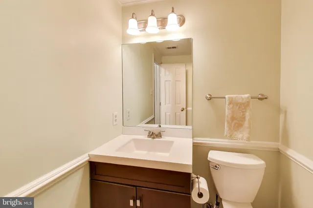 a bathroom with a sink a toilet and mirror