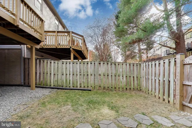 a view of a house with wooden fence