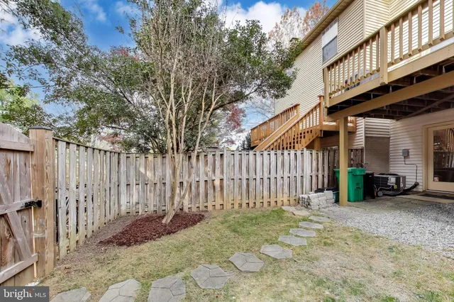 a view of a house with wooden fence
