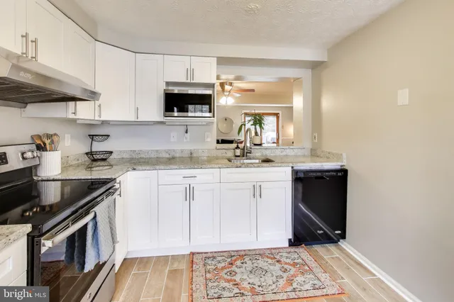 a kitchen with a sink stove and microwave