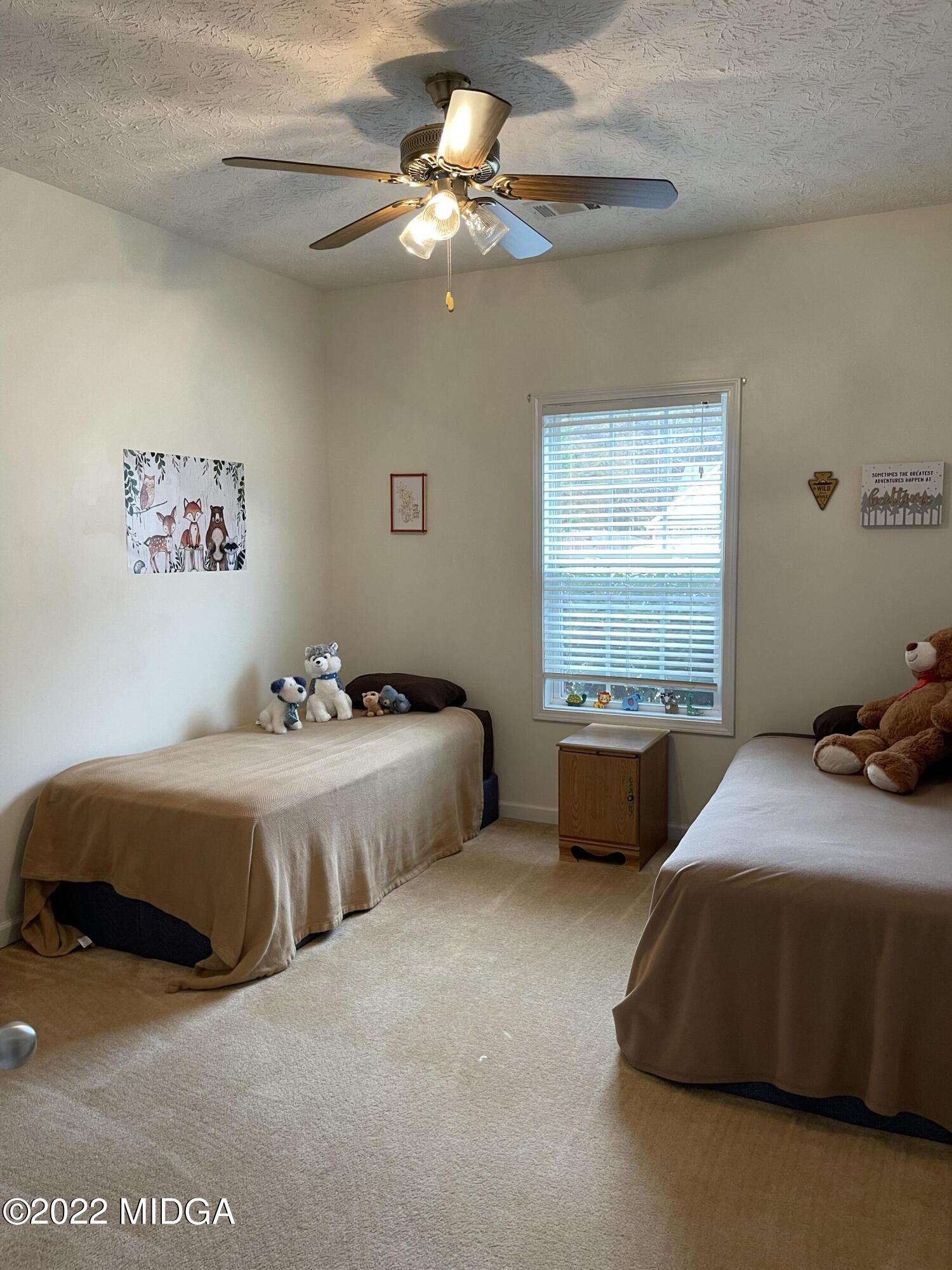 90 Hickory Road Jackson, GA 30233 - Photo 12 of 19 a bedroom with a bed dresser and window