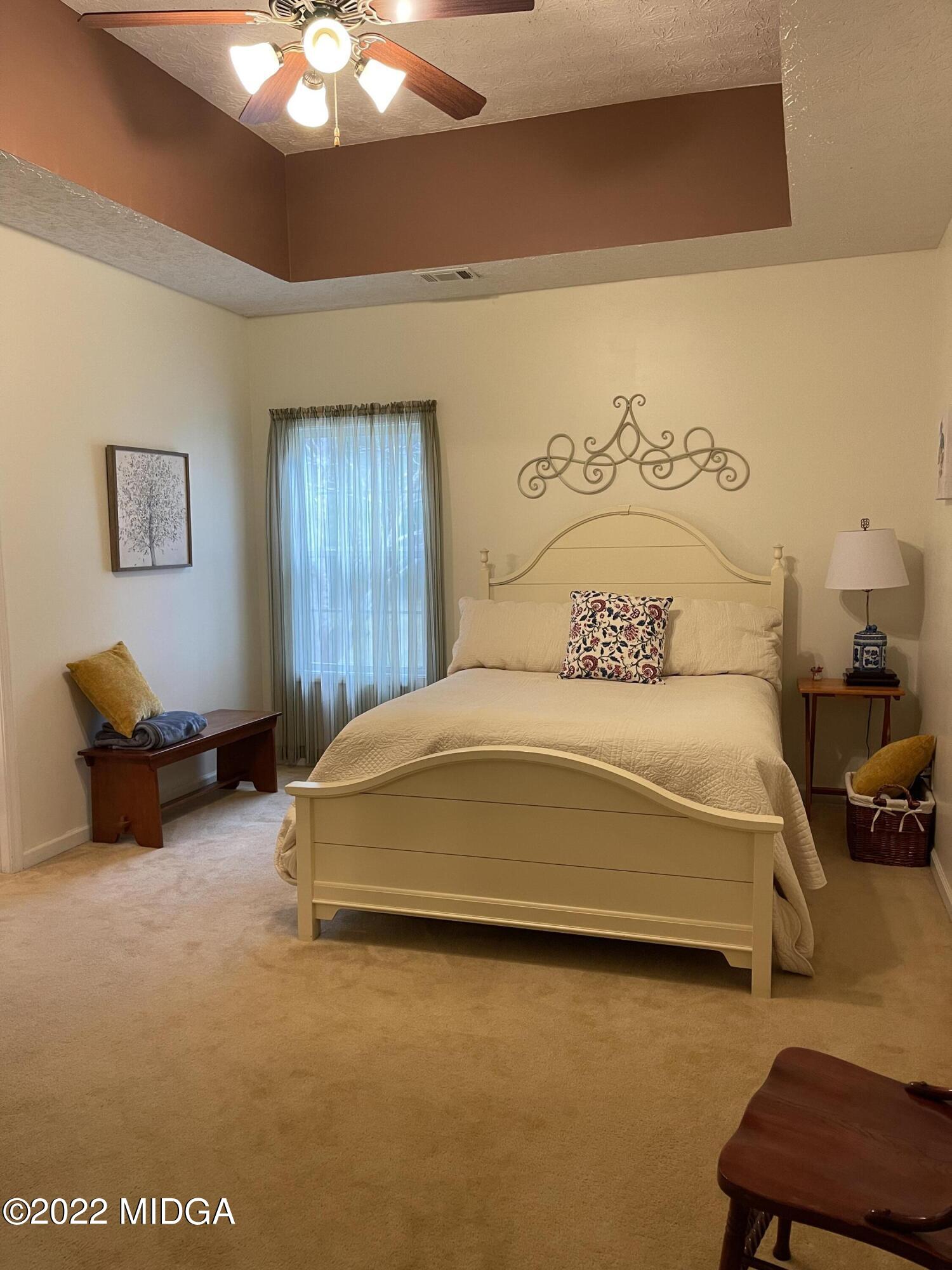 90 Hickory Road Jackson, GA 30233 - Photo 16 of 19 a bedroom with a bed and a lamp on dresser