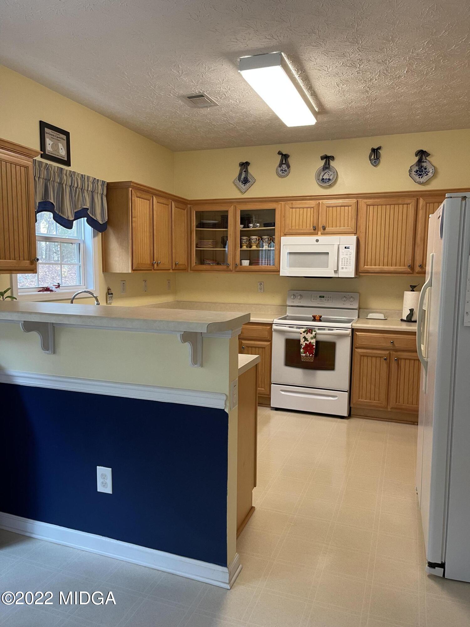 90 Hickory Road Jackson, GA 30233 - Photo 7 of 19 a kitchen with a stove and a refrigerator