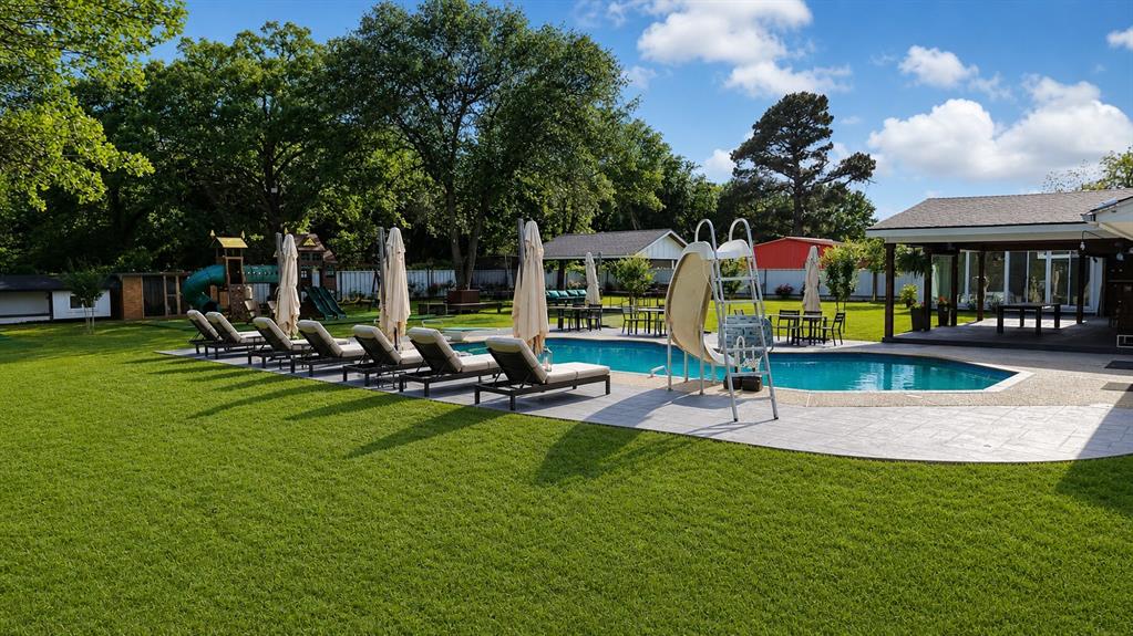 620 East 6th Street Springtown, TX 76082 - Photo 20 of 40 a view of a house with backyard patio and swimming pool