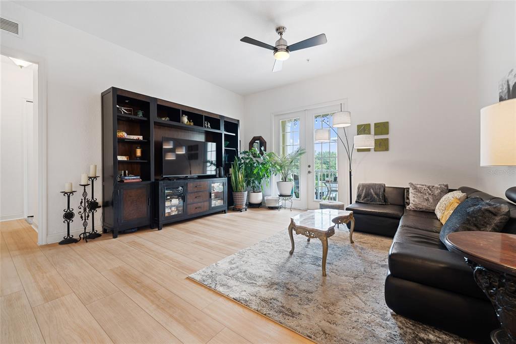 1819 Common Way Road, Unit 203 Orlando, FL 32814 - Photo 10 of 23 a living room with furniture and a flat screen tv