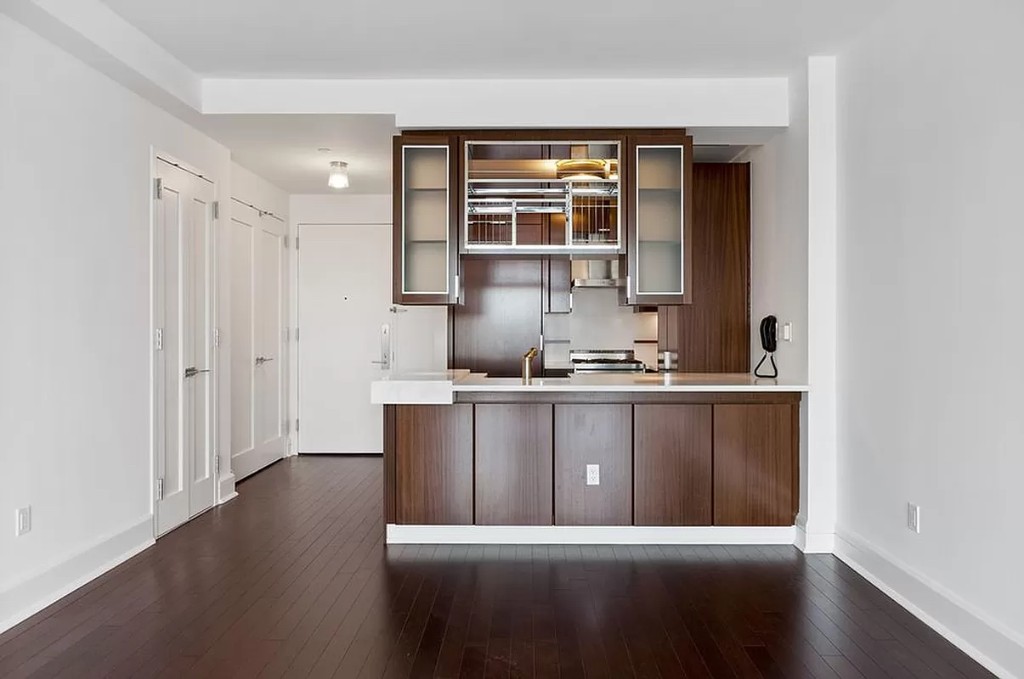 60 Riverside Boulevard, Unit 1707 Manhattan, NY 10069 - Photo 5 of 20 a kitchen with a refrigerator and a window