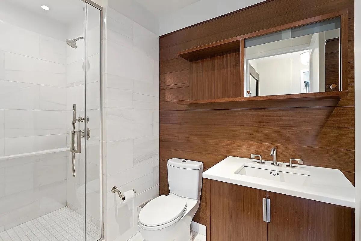 60 Riverside Boulevard, Unit 1707 Manhattan, NY 10069 - Photo 8 of 20 a bathroom with a sink toilet and shower