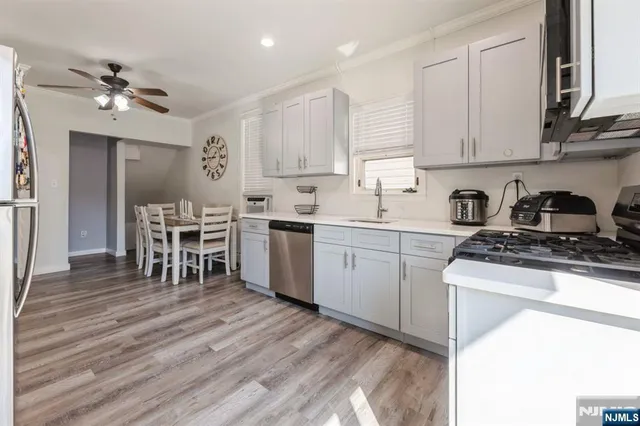 a kitchen with a sink cabinets and wooden floor
