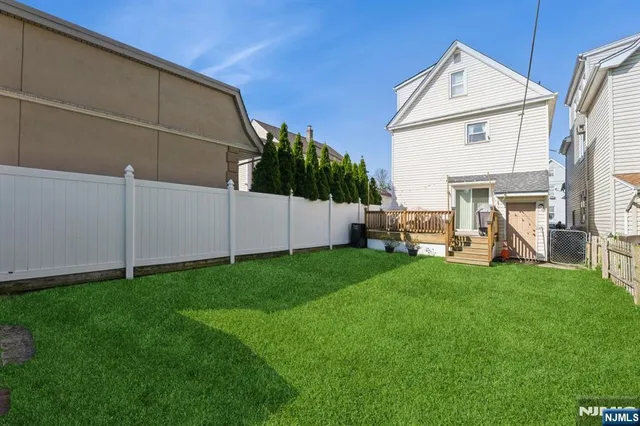 a front view of a house with a garden and yard