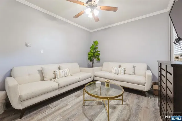 a living room with furniture a chandelier and a couch