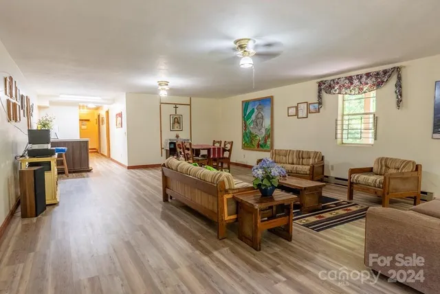 a living room with furniture and wooden floor