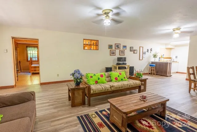a living room with furniture and wooden floor
