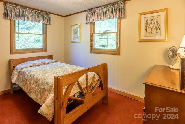 a kitchen with sink a refrigerator and chairs