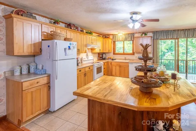 a view of a dining room with furniture a chandelier and wooden floor