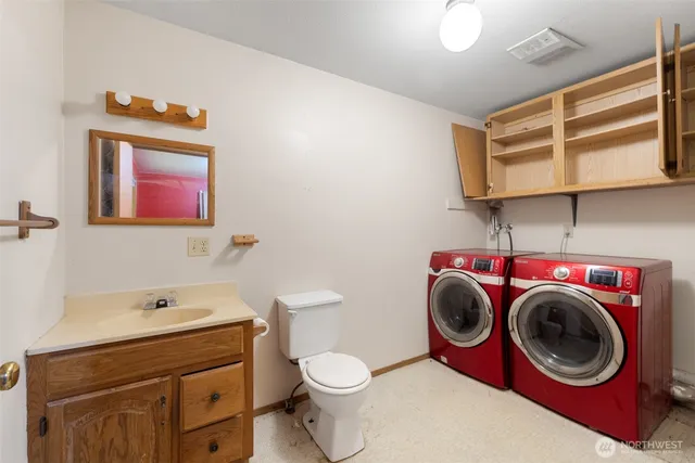 a bathroom with a toilet a sink and a mirror