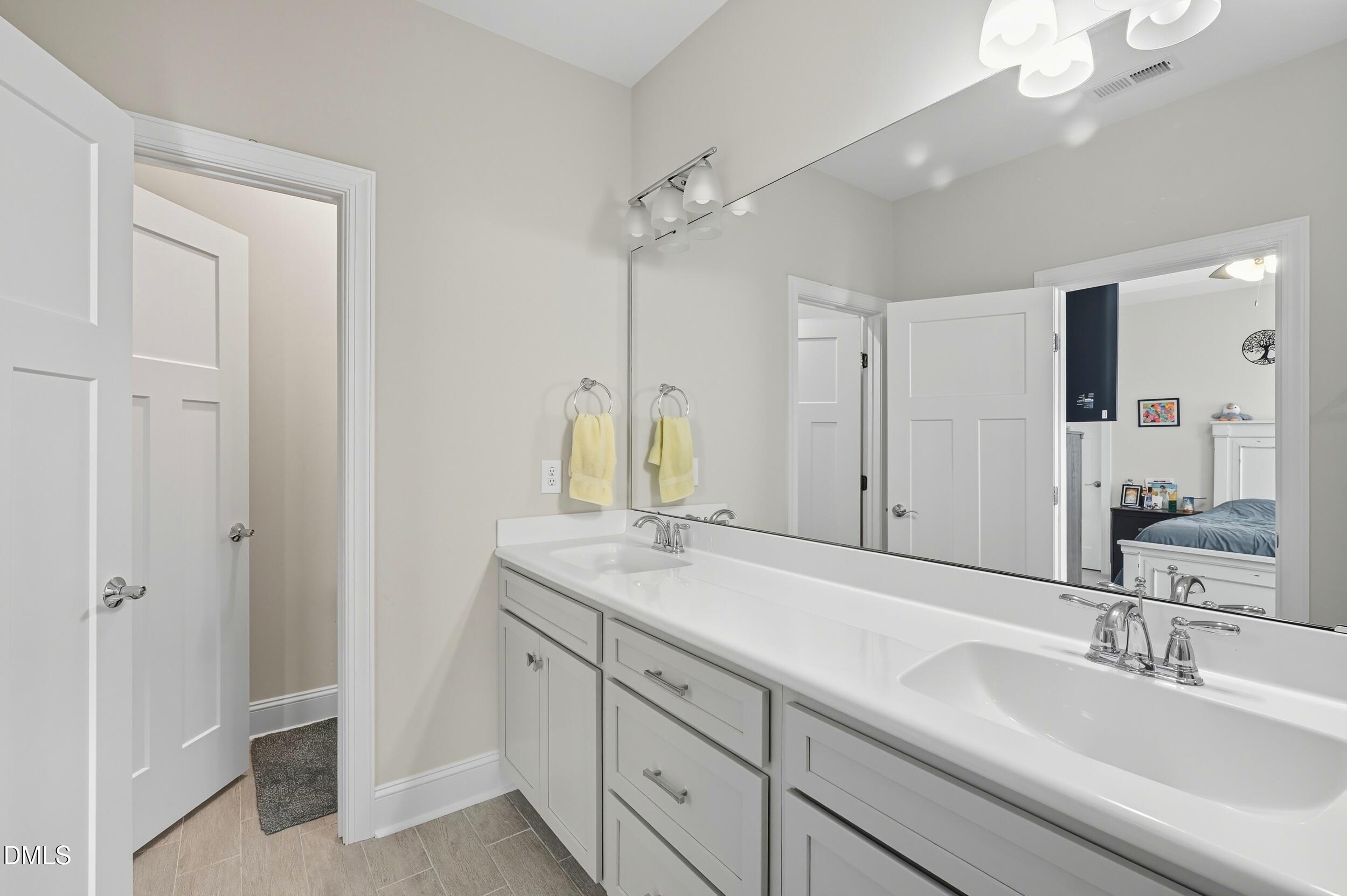 116 Beaufort Loop Clayton, NC 27520 - Photo 12 of 33 a bathroom with a sink and a mirror