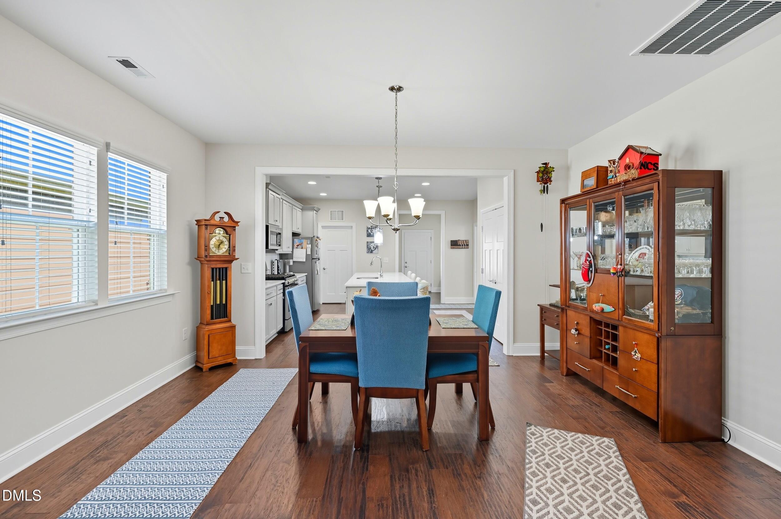 116 Beaufort Loop Clayton, NC 27520 - Photo 15 of 33 a view of a dining room with furniture and wooden floor