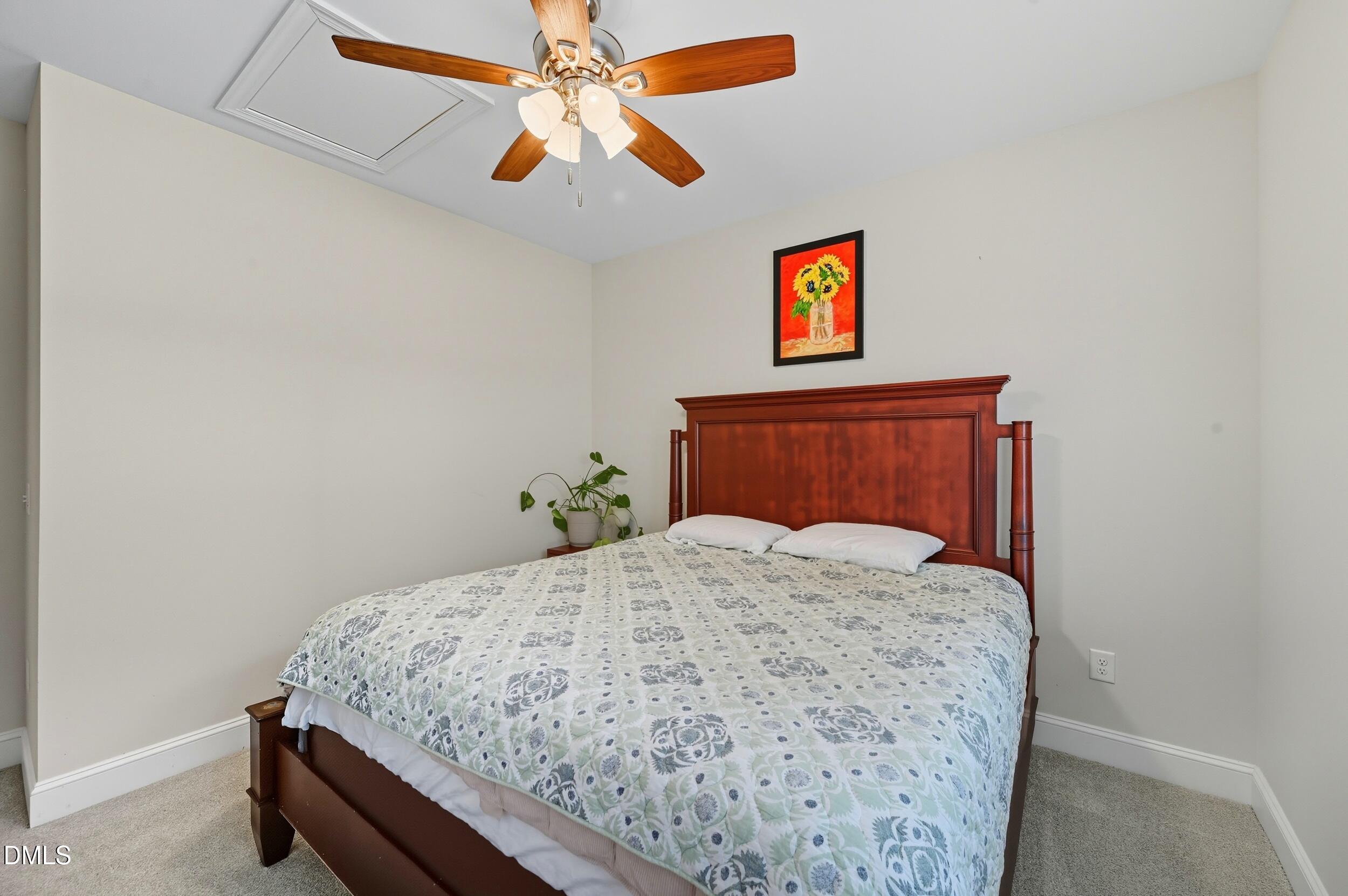 116 Beaufort Loop Clayton, NC 27520 - Photo 20 of 33 a bedroom with a bed and a chandelier