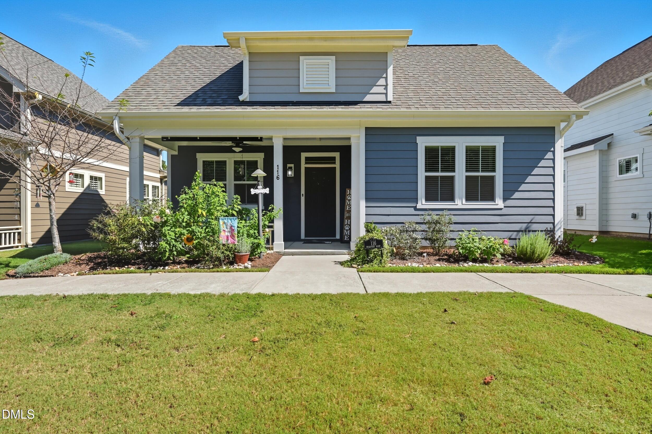 116 Beaufort Loop Clayton, NC 27520 - Photo 2 of 33 a front view of a house with garden