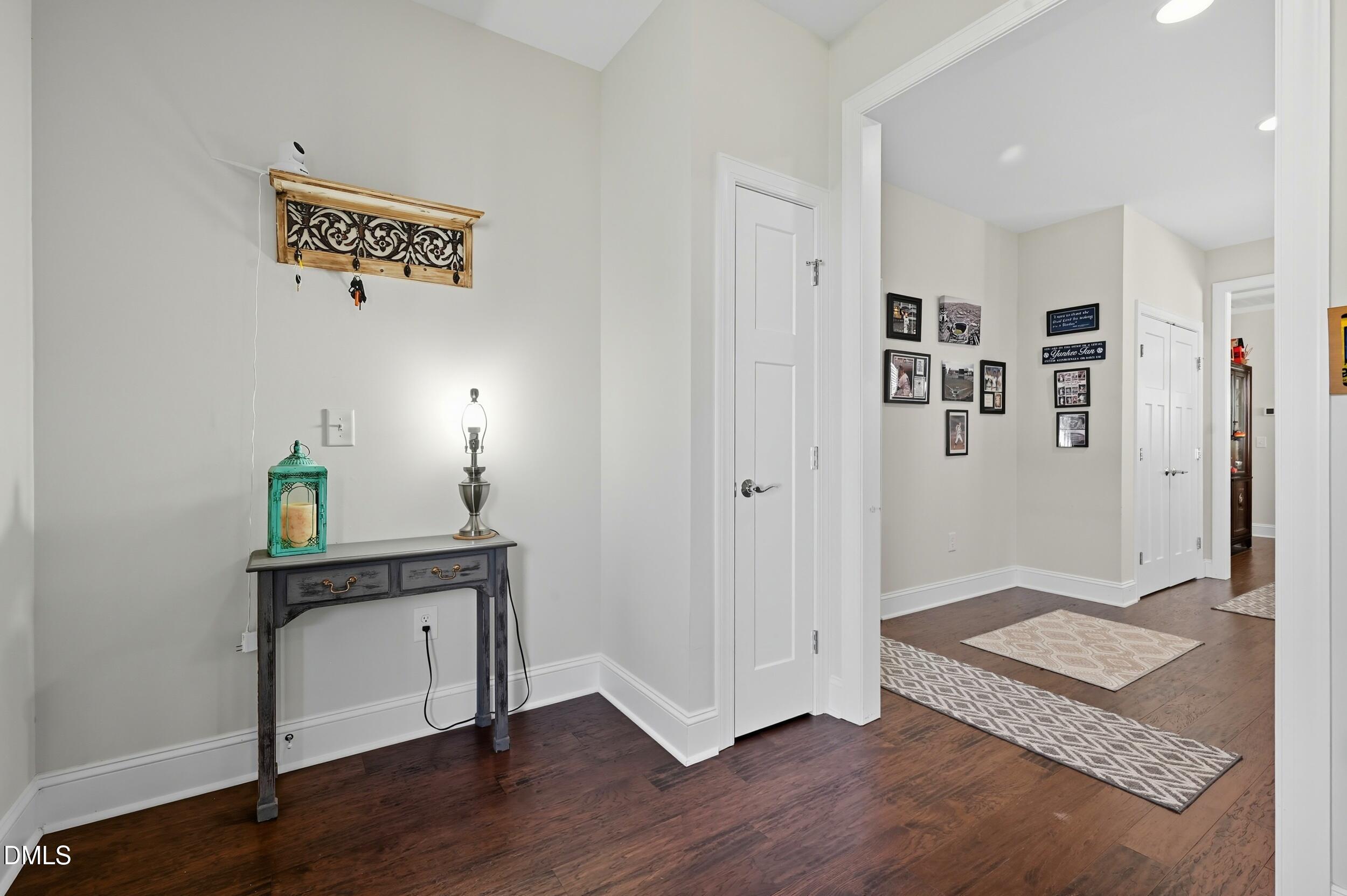 116 Beaufort Loop Clayton, NC 27520 - Photo 4 of 33 a view of a hallway with wooden floor and furniture