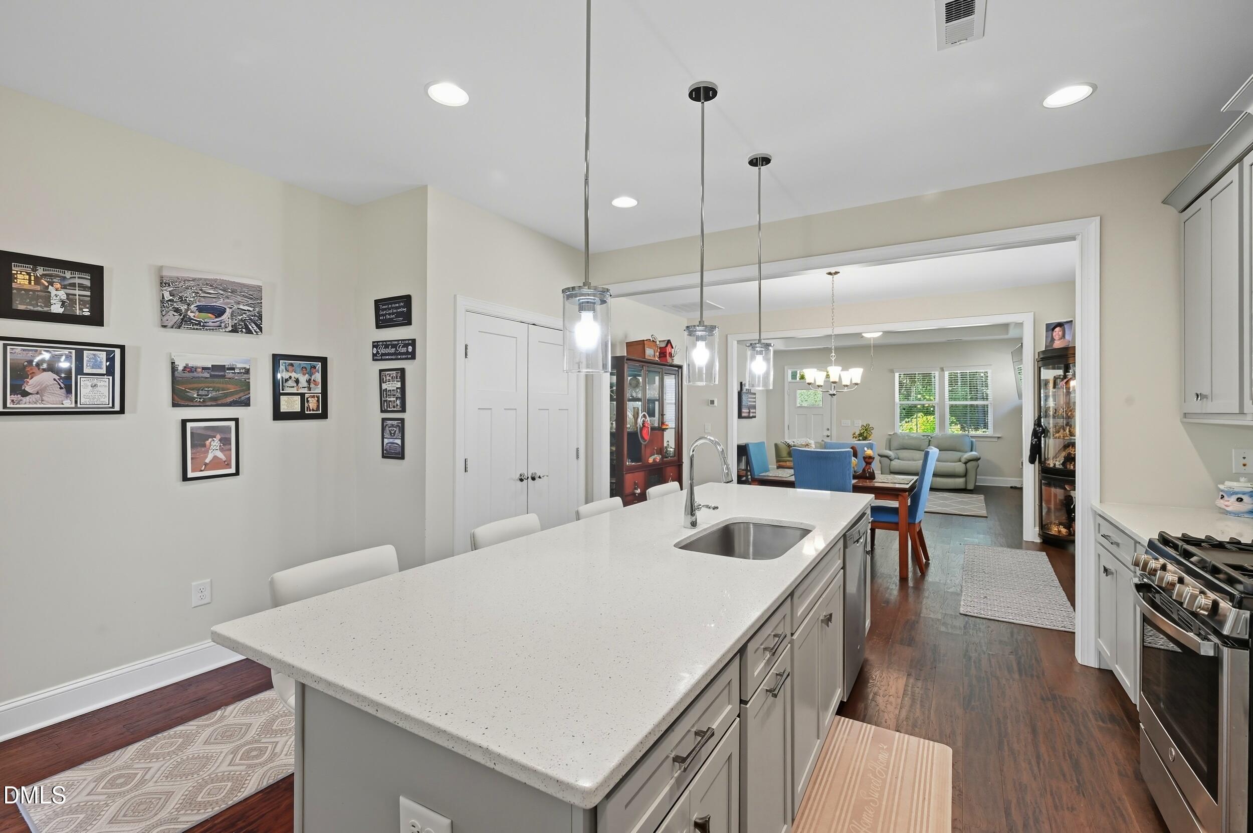 116 Beaufort Loop Clayton, NC 27520 - Photo 5 of 33 a large kitchen with sink a refrigerator a stove and a wooden floors