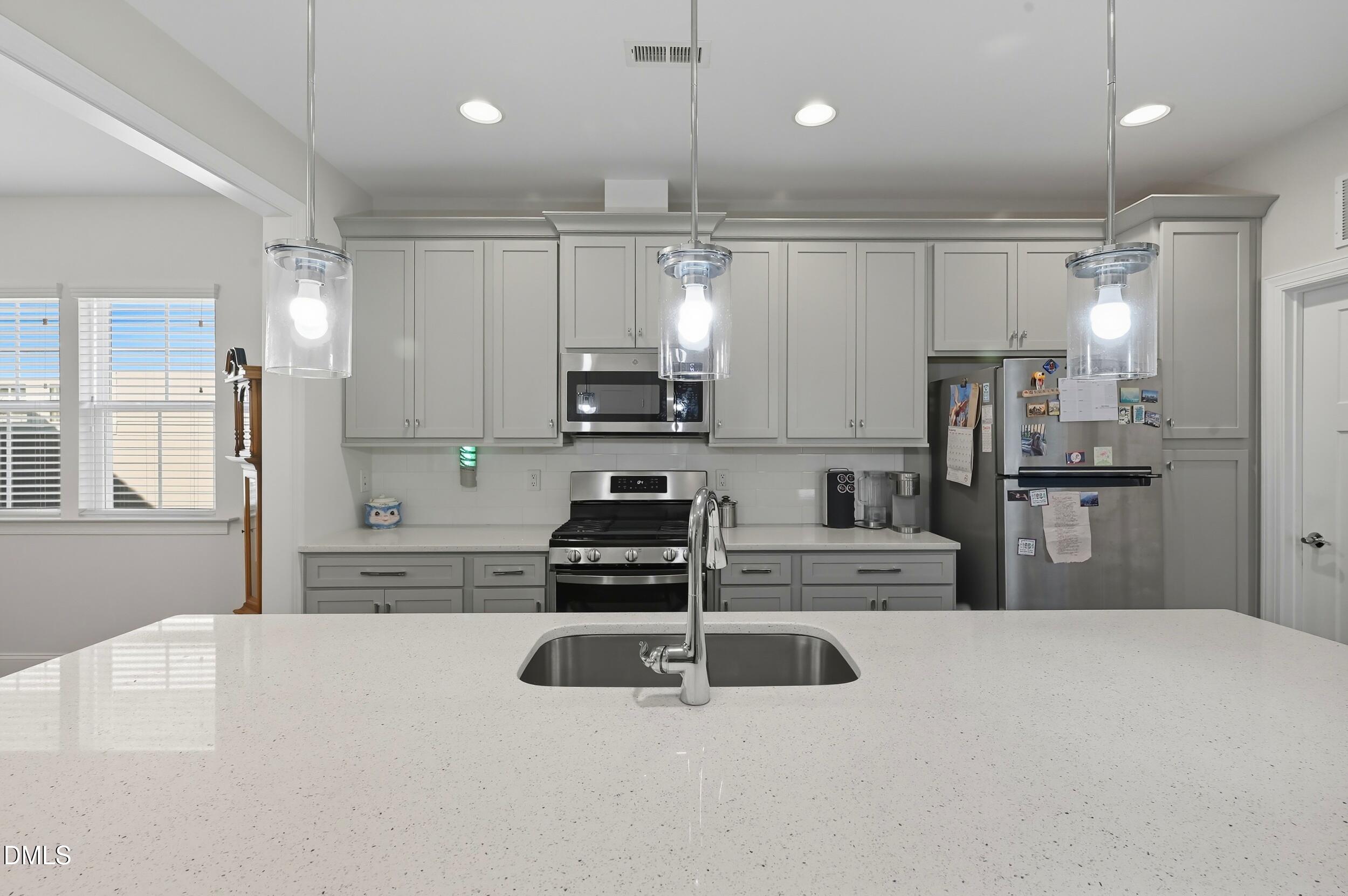 116 Beaufort Loop Clayton, NC 27520 - Photo 8 of 33 a kitchen with kitchen island a counter top space appliances and cabinets