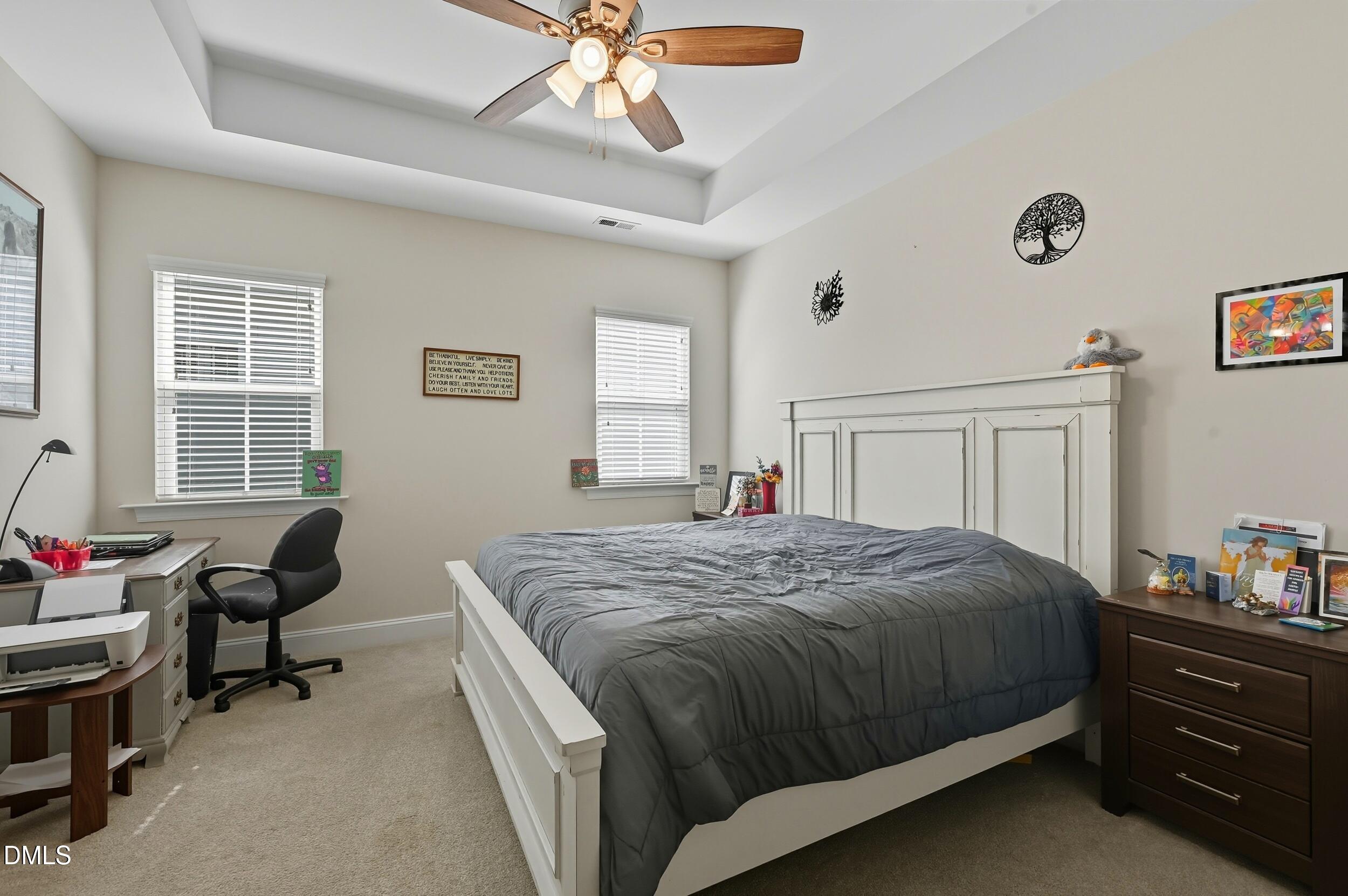 116 Beaufort Loop Clayton, NC 27520 - Photo 9 of 33 a bedroom with a bed and a chandelier