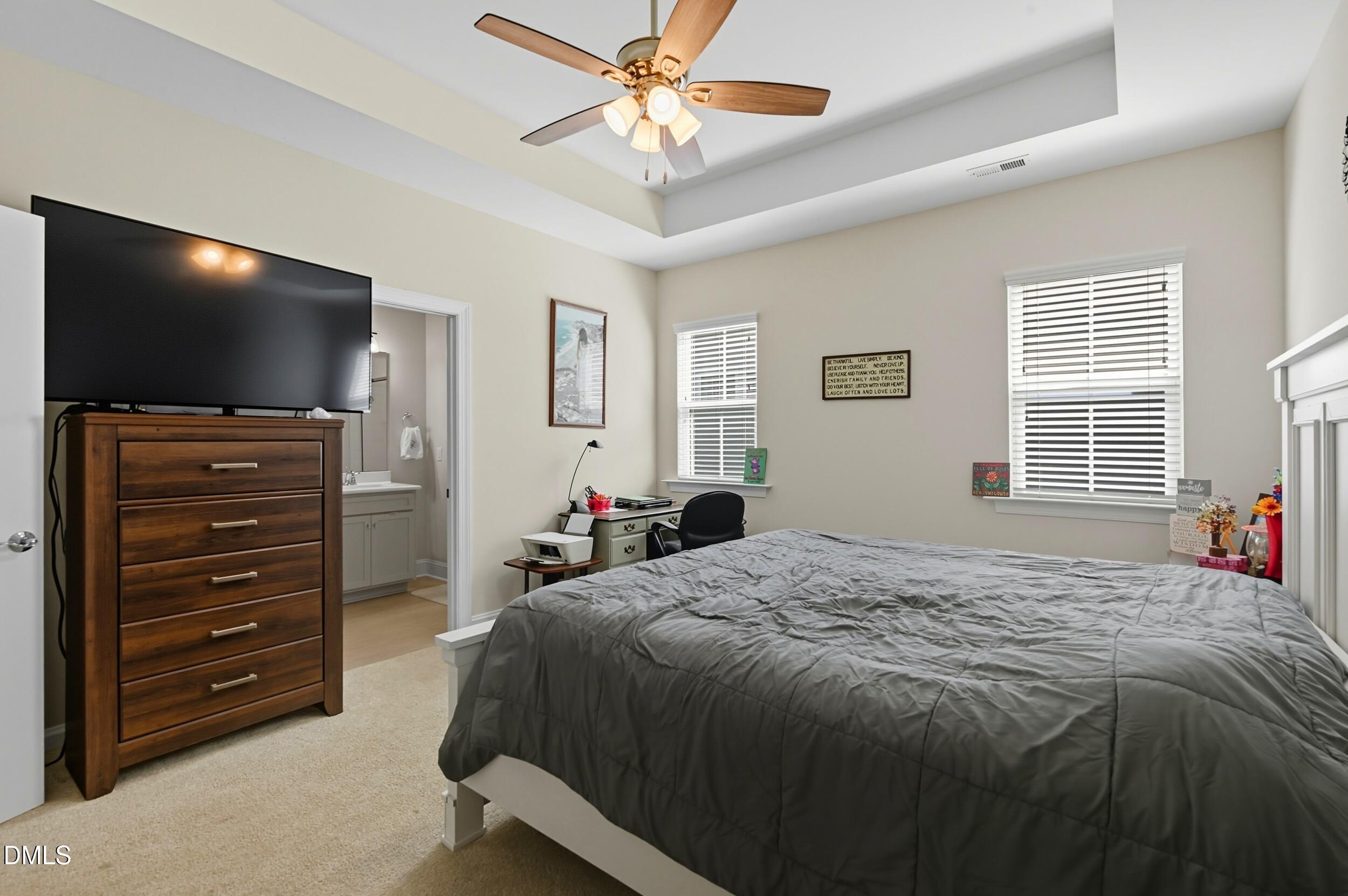 116 Beaufort Loop Clayton, NC 27520 - Photo 10 of 33 a bed sitting in a bedroom and flat screen tv